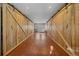 Hallway with wood floors and large barn doors leading to further rooms, providing a unique design element at 6080 Kilimanjaro Dr, Evergreen, CO 80439