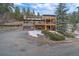 This home boasts multiple decks, a two car garage, and a wooded lot at 6080 Kilimanjaro Dr, Evergreen, CO 80439