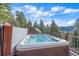 This hot tub is located on a wooden deck and features scenic mountain and forest views at 6080 Kilimanjaro Dr, Evergreen, CO 80439