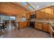 Eat-in kitchen features natural wood cabinets and beams with granite countertops, and dining table with view at 6080 Kilimanjaro Dr, Evergreen, CO 80439