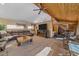 Open concept living room has wood beam ceilings, ceiling fan, and is adjacent to the dining area at 6080 Kilimanjaro Dr, Evergreen, CO 80439