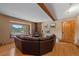 Inviting living room features a stone fireplace, beautiful wood floors, and large view window at 6080 Kilimanjaro Dr, Evergreen, CO 80439