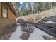 This patio area features a brick paver floor, metal furniture, and wood retaining walls at 6080 Kilimanjaro Dr, Evergreen, CO 80439