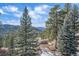 This gorgeous wooded property features scenic views and a foot bridge to get around at 6080 Kilimanjaro Dr, Evergreen, CO 80439