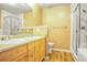 Bright bathroom featuring a double sink vanity and glass-enclosed shower and separate tub at 8552 Gold Peak Ln # F, Highlands Ranch, CO 80130