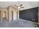 Large bedroom with stylish ceiling fan, accent wall, carpet floors, and closet space at 8552 Gold Peak Ln # F, Highlands Ranch, CO 80130