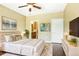 Cozy bedroom suite with ensuite bathroom, ceiling fan, and warm neutral tones at 8552 Gold Peak Ln # F, Highlands Ranch, CO 80130