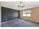 Modern bedroom with stylish ceiling fan, accent wall, and window for natural light at 8552 Gold Peak Ln # F, Highlands Ranch, CO 80130