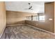 Spacious bonus room with plush carpeting, ceiling fan and staircase railing at 8552 Gold Peak Ln # F, Highlands Ranch, CO 80130