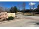 Community entrance featuring a rock formation with the neighborhood name, Gold Peak, on it at 8552 Gold Peak Ln # F, Highlands Ranch, CO 80130