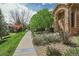Attractive exterior of this brick home showing stone archway, landscaping and walkway at 8552 Gold Peak Ln # F, Highlands Ranch, CO 80130