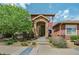 Inviting front entrance with a stone archway and well-maintained landscaping at 8552 Gold Peak Ln # F, Highlands Ranch, CO 80130