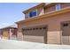 Attached two car garage featuring an automatic overhead door and neutral colored siding at 8552 Gold Peak Ln # F, Highlands Ranch, CO 80130