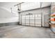 Spacious two car garage with overhead door, concrete floor, and built in shelves at 8552 Gold Peak Ln # F, Highlands Ranch, CO 80130