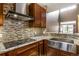 Close-up of a well-appointed kitchen, featuring granite counters and stylish backsplash at 8552 Gold Peak Ln # F, Highlands Ranch, CO 80130