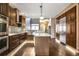 Spacious kitchen with dark wood cabinets, stainless steel appliances, and a large island at 8552 Gold Peak Ln # F, Highlands Ranch, CO 80130