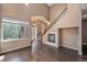 Spacious living room with fireplace, staircase, and hardwood floors at 8552 Gold Peak Ln # F, Highlands Ranch, CO 80130