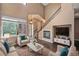 Bright living room featuring a fireplace, high ceilings, and comfortable seating area at 8552 Gold Peak Ln # F, Highlands Ranch, CO 80130