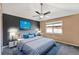 Modern bedroom with stylish ceiling fan, accent wall, ocean art, and window for natural light at 8552 Gold Peak Ln # F, Highlands Ranch, CO 80130