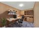 Home office area with wooden built-in shelves, desk, and comfortable chair at 8552 Gold Peak Ln # F, Highlands Ranch, CO 80130
