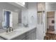 Bathroom with double sinks, shower with glass door, and walk-in closet at 16062 E Geddes Dr # 150, Aurora, CO 80016