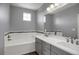 Gray bathroom with white subway tile, and double sink vanity at 16062 E Geddes Dr # 150, Aurora, CO 80016