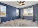 Bedroom with two large windows, a ceiling fan, and neutral carpeting at 16062 E Geddes Dr # 150, Aurora, CO 80016