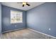 This bedroom has a ceiling fan and a window at 16062 E Geddes Dr # 150, Aurora, CO 80016