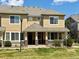 Inviting townhouse featuring a covered porch and manicured front lawn, perfect for relaxing outdoors at 16062 E Geddes Dr # 150, Aurora, CO 80016