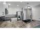 Modern kitchen with stainless steel refrigerator, white cabinets, and stylish countertops at 16062 E Geddes Dr # 150, Aurora, CO 80016