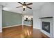 Open-concept living room with a fireplace and kitchen access, perfect for entertaining and modern living at 16062 E Geddes Dr # 150, Aurora, CO 80016
