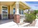 Close-up of the porch, with decorative brick pillars and white railing, adding charm to the entrance at 16062 E Geddes Dr # 150, Aurora, CO 80016