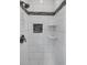 Modern shower with tile design, built-in shelves, and bronze hardware at 16062 E Geddes Dr # 150, Aurora, CO 80016