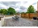 View of a backyard, showcasing a paved patio with dining area, landscaping, and fencing at 1803 E 36Th Ave, Denver, CO 80205