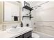 The bathroom has shelves, a tub, toilet and black accents at 1803 E 36Th Ave, Denver, CO 80205