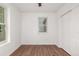 This bedroom has wood-look floors, white walls and a window at 1803 E 36Th Ave, Denver, CO 80205
