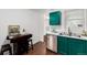 A kitchen featuring stainless steel appliances, green cabinets, marbled countertops, and a wine rack at 1803 E 36Th Ave, Denver, CO 80205