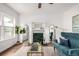 Bright and stylish living room features a fireplace, hardwood floors, and contemporary decor at 1803 E 36Th Ave, Denver, CO 80205