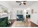 Inviting living room with accent chair, decorative fireplace, and a glimpse into the kitchen at 1803 E 36Th Ave, Denver, CO 80205