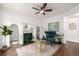 Stylish living room features a modern ceiling fan, fireplace, decorative rug, and a comfortable accent chair at 1803 E 36Th Ave, Denver, CO 80205