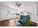 Sun-filled living room showcasing stylish decor, a fireplace, and wood-look flooring at 1803 E 36Th Ave, Denver, CO 80205
