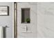 Marble tiled shower niche, with a plant, towel bar, and squeegee at 1410 York St # 35, Denver, CO 80206