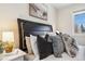 Bedroom with an inviting plush headboard and a bedside table at 1410 York St # 35, Denver, CO 80206