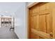 View of a unit's wooden door, number 35, in a hallway with carpet and a seating area, creating a welcoming entrance at 1410 York St # 35, Denver, CO 80206