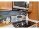 Stainless steel electric stovetop, and stainless steel microwave and white countertop at 1410 York St # 35, Denver, CO 80206