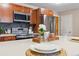 Modern kitchen featuring stainless steel appliances, granite countertops, and warm wood cabinetry at 1410 York St # 35, Denver, CO 80206