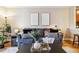 Stylishly decorated living room featuring a comfortable sofa, modern art, and hardwood flooring at 1410 York St # 35, Denver, CO 80206