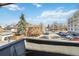 View from the balcony, showing parked cars, street, houses, and blue sky at 1410 York St # 35, Denver, CO 80206