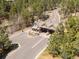 Aerial view of a secure gated community entry surrounded by lush green trees and well-maintained roads at 6877 Northstar Ct, Castle Rock, CO 80108