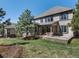Spacious backyard featuring a well-maintained lawn, large patio, and partial view of the exterior elevation at 6877 Northstar Ct, Castle Rock, CO 80108